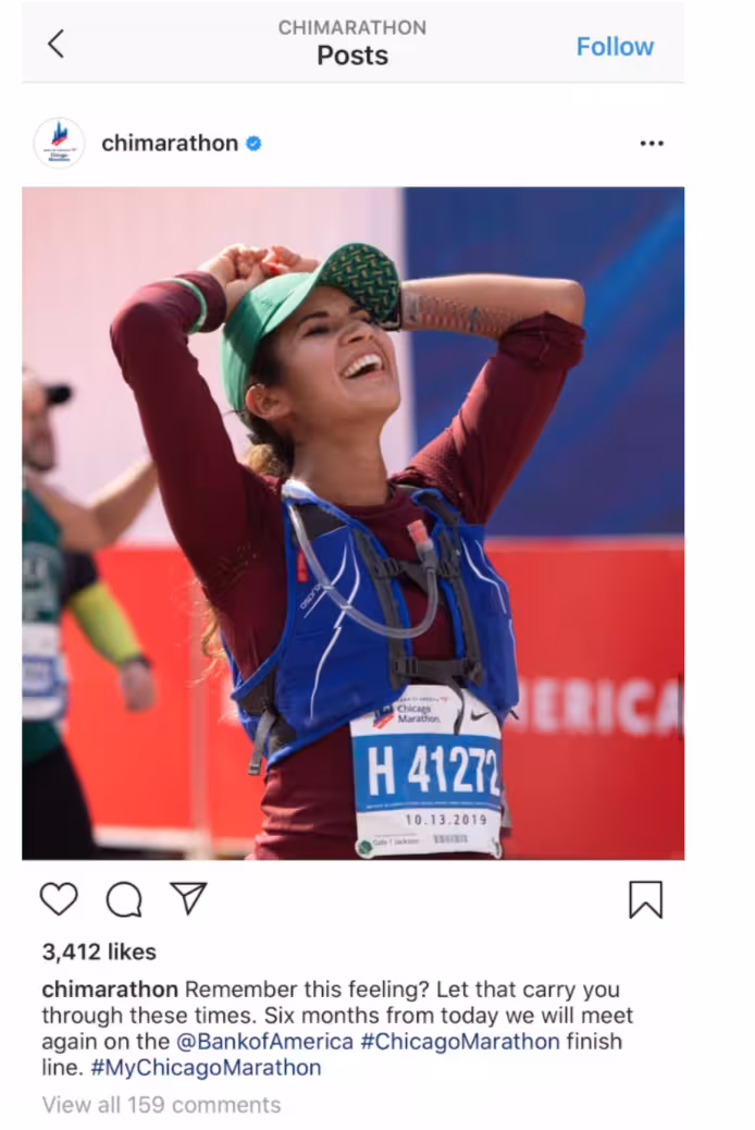 Photo of a marathon runner smiling with arms raised in celebration while wearing race gear, shared in a motivational post about future race moments.